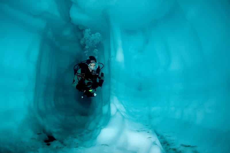 Subacqueo all'interno di una grotta di ghiaccio, lago Sassolo, valle del Sambuco, Ticino, Svizzera